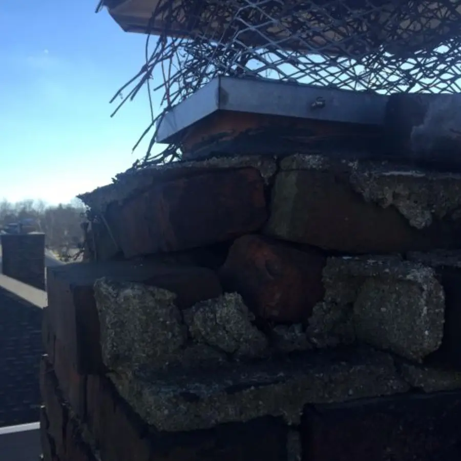 Damaged chimney masonry before repair