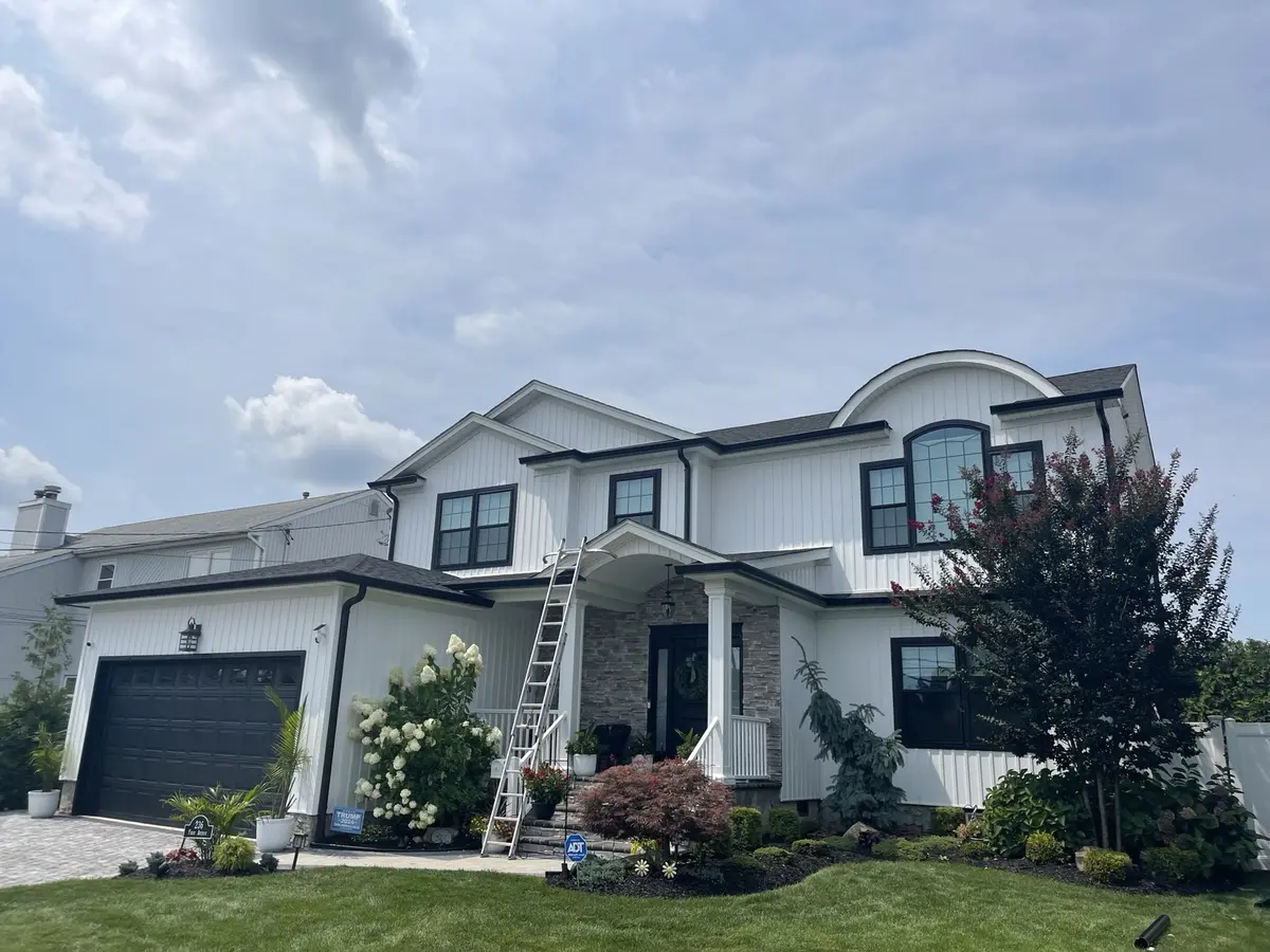 Completed black gutter and downspout installation