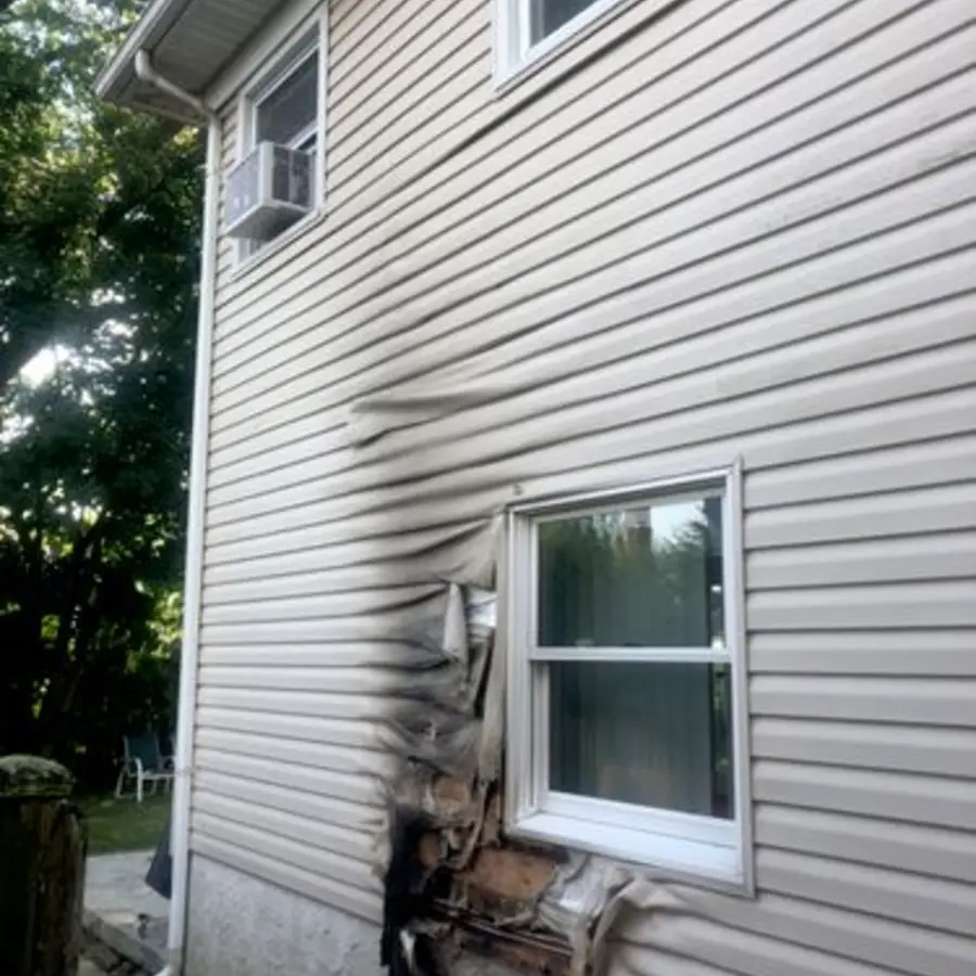Fire-damaged siding before repair